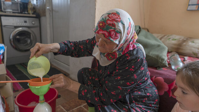Sabie pours milk through a sieve to remove any impurities as she bottles it in used cola bottles and then delivers to customers in Velingrad. Her granddaughter, also named Sabie, watches. Most younger community members aren’t following their parents’ example and the tradition will likely die out. Sabie pours milk through a sieve to remove any impurities as she bottles it in used cola bottles and then delivers to customers in Velingrad. Her granddaughter, also named Sabie, watches. Most younger community members aren’t following their parents’ example and the tradition will likely die out.