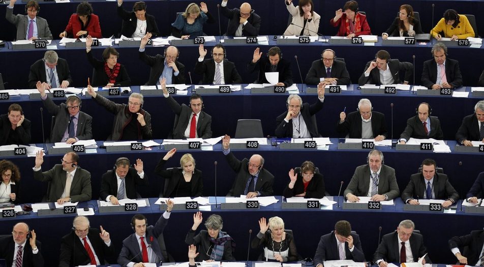 Members of the European Parliament vote during a voting session on the EU budget at the European Parliament in Strasbourg.