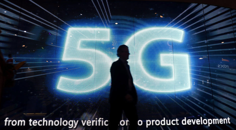 A visitors walks past a 5G sign during Mobile World Congress in Barcelona, Spain