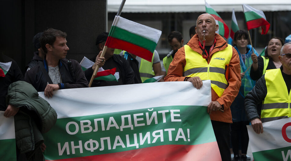 Protesters holding a Bulgarian flag with the caption "get inflation under control" during a protest in Sofia on Wednesday