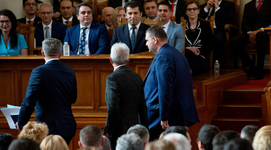Petkov and Vassilev (in the background) look at passing MRF MP Delyan Peevski just before the vote of no-confidence